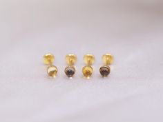 ❝ Introducing our exquisite threadless push pin studs featuring the captivating combination of citrine and smoky quartz cabochons. The harmonious pairing of these two stunning gemstones creates a visually captivating and enchanting display. Designed with your comfort in mind, our threadless push pin studs offer a seamless fit with their flat back design. Each stud is meticulously handcrafted in our Toronto studio, reflecting exceptional craftsmanship and style. Elevate your jewelry collection wi Gold Gemstone Piercings As A Gift, Gold Gemstone Piercings For Gifts, Internally Threaded Round Nose Studs As Gift, Internally Threaded Yellow Gold Nose Studs, Internally Threaded Round Yellow Gold Nose Studs, Cartilage Earring, Natural Citrine, Clean Hands, Cartilage Earrings