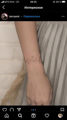 a woman's arm with a small tattoo on the left side of her wrist