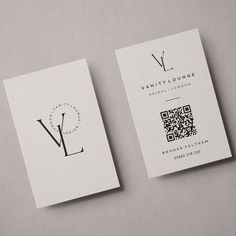 two business cards with q and v on them