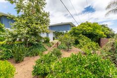 a house surrounded by trees and bushes