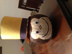 a paper mache with a monkey wearing a top hat on it's head