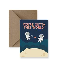 a card with an astronaut couple holding hands on top of a hill, and the text you're outa this world