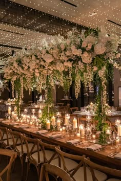 a long table with candles and flowers on it is set up for a formal function