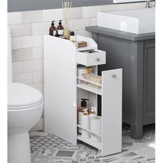 a bathroom with a sink and toilet next to a cabinet in the middle of the floor