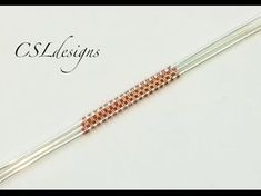 an orange and white beaded bracelet with two metal rods attached to the clasps