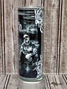 a black and white photo of a man with roses on it's face sitting in front of a wooden wall