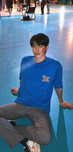 a boy sitting on the floor with his skateboard