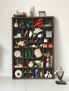 a wooden shelf filled with figurines and other items