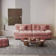 a living room with pink couches and coffee table in the middle, on carpeted flooring