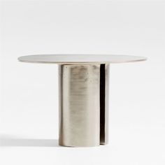 a round table with a white top and silver metal base, against a white background