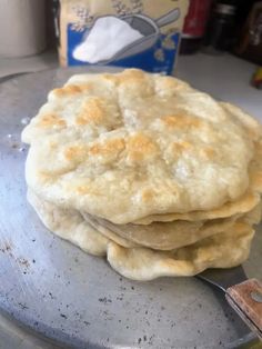 a stack of flat bread sitting on top of a metal pan