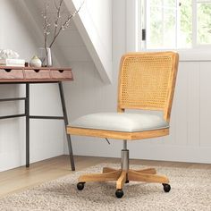 an office chair sitting on top of a rug in front of a desk and window