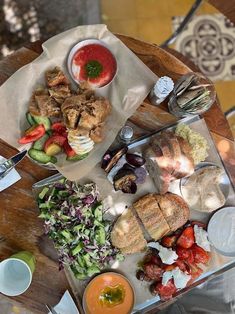 a wooden table topped with lots of food