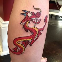 a red and yellow dragon tattoo on the right leg, it appears to be in color