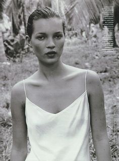 a black and white photo of a woman with short hair wearing a top that says, thisiswhistles