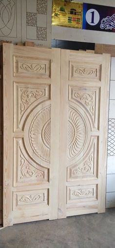 two wooden doors with intricate carvings on them