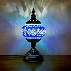 a blue and white lamp sitting on top of a wooden table