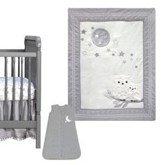 a baby crib and bedding set with an owl on the night sky theme