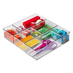 an organized drawer with scissors, beads and other crafting supplies in it on a white background