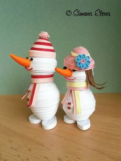 two snowmen are standing next to each other