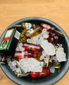 a bucket full of beer bottles and ice cubes