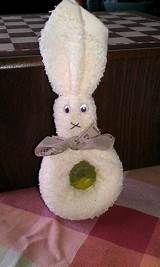 a white stuffed rabbit sitting on top of a table