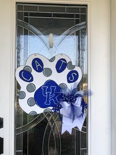 the front door is decorated with a blue and white cat's paw, which reads cats