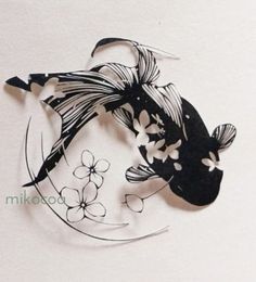 a paper cut out of a fish with flowers on it's back and side