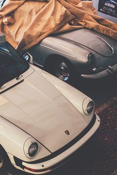 two porsches are parked next to each other