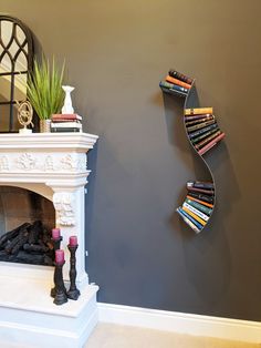 a white fireplace with books on the mantle