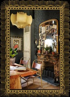 an ornately decorated dining room with a fireplace and table in the center, surrounded by pictures on the wall