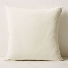 a white pillow sitting on top of a table