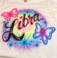 a t - shirt with the word libra painted on it's chest and butterflies