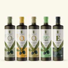 three bottles of organic olive oil with green leaves on the top and bottom, in front of white background