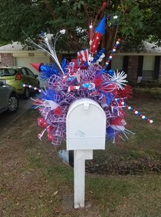 a mailbox decorated with red, white and blue decorations