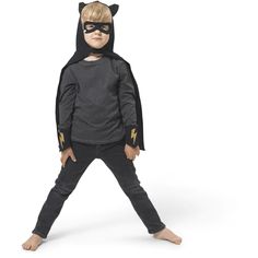 a little boy dressed in a cat costume