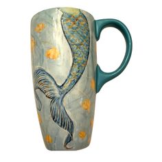 a coffee cup with a fish painted on it