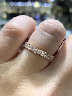 a woman's hand with a diamond ring on it