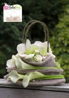 a hat with flowers is sitting on a ledge