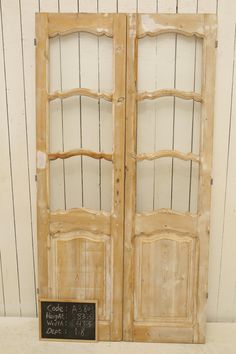 an old pair of doors with chalkboard on the front and side panels in between them