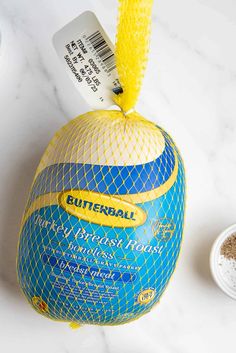 a blue and yellow ball sitting on top of a white counter