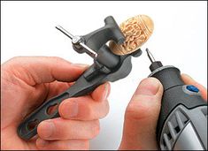 a person holding a small tool in their left hand, with a corkscrew sticking out of it