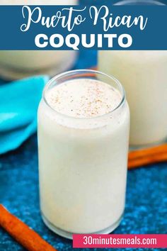 two glasses filled with mexican coquito sitting on top of a blue tablecloth