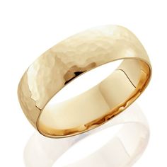 a yellow gold wedding ring with hammered finish on the outside and inlayed to it's surface