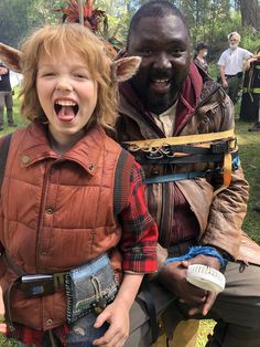 a young boy and an older man in costume