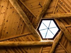 the inside of a wooden structure with a skylight