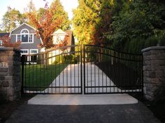 a gated driveway leading to a house