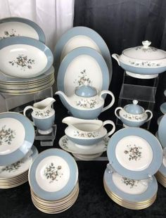 a table topped with lots of blue and white dishes