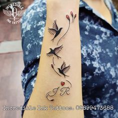 a woman's arm with three birds on it and the word love written in cursive writing