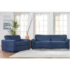 a living room with two blue couches and a rug